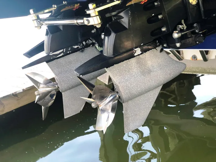  Yacht Photos Pics 2013 Nor-Tech 477 SPX Vee Bottom boat propellers in water, showcasing sleek design.