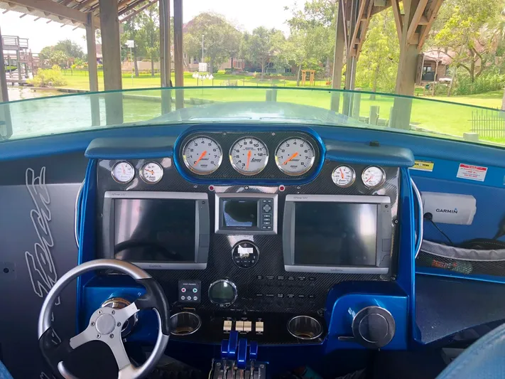  Yacht Photos Pics 2013 Nor-Tech 477 SPX Vee Bottom dashboard with gauges and navigation screens.