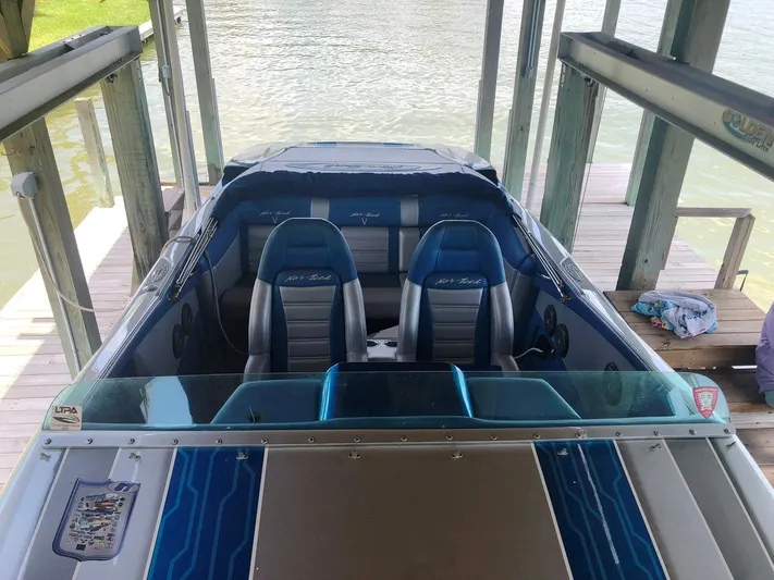  Yacht Photos Pics 2013 Nor-Tech 477 SPX Vee Bottom boat docked, featuring blue and gray seating.
