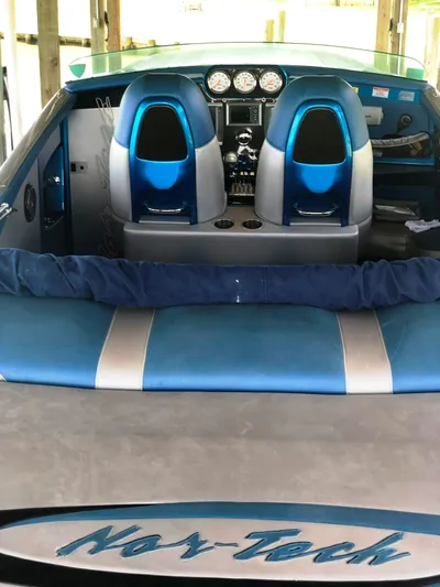  Yacht Photos Pics 2013 Nor-Tech 477 SPX Vee Bottom boat interior with blue seats and dashboard.
