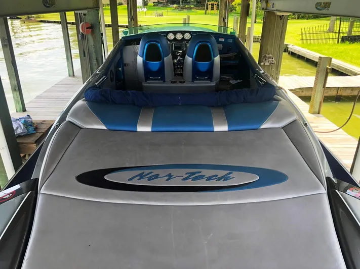  Yacht Photos Pics 2013 Nor-Tech 477 SPX Vee Bottom boat docked, featuring sleek blue and gray design.