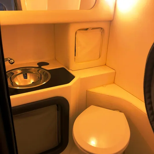 Yacht Photos Pics Interior of 2013 Nor-Tech 477 SPX Vee Bottom boat bathroom with sink and toilet.