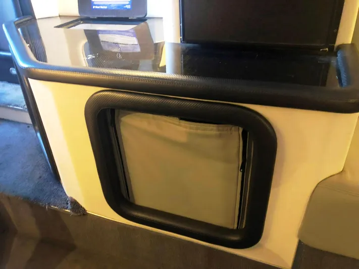  Yacht Photos Pics 2013 Nor-Tech 477 SPX Vee Bottom interior detail with sleek black trim and storage compartment.