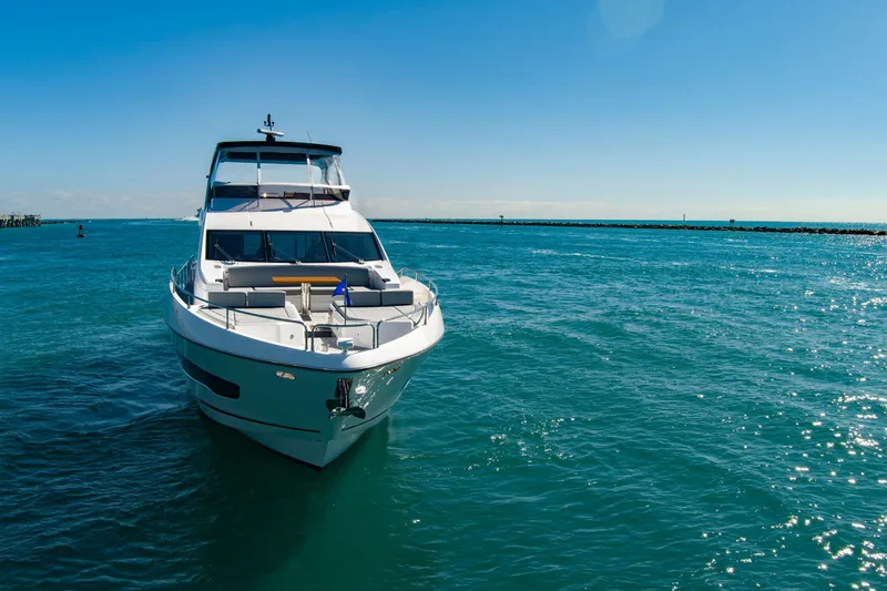 Misty K Yacht Photos Pics 2024 Sunseeker 76 Yacht cruising on clear blue ocean under sunny sky.