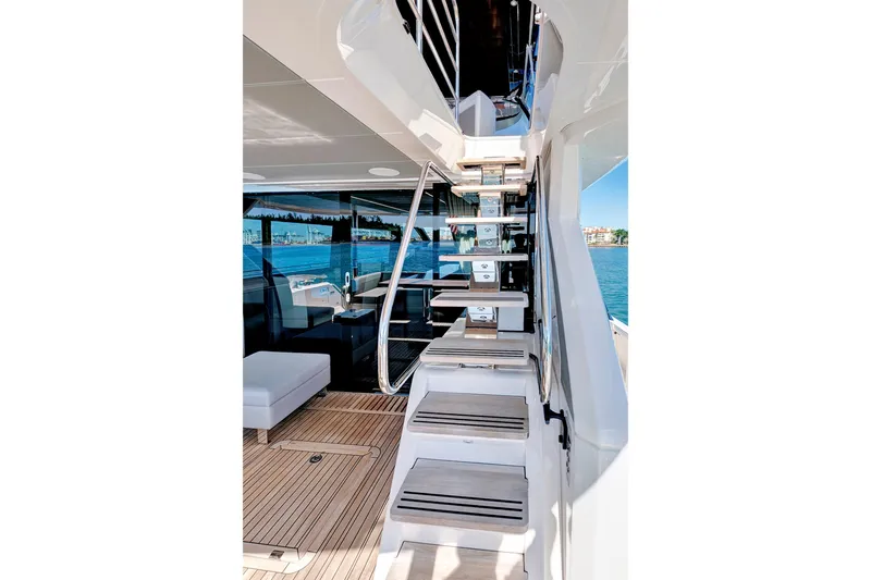 Misty K Yacht Photos Pics 2024 Sunseeker 76 Yacht interior with modern staircase and ocean view.