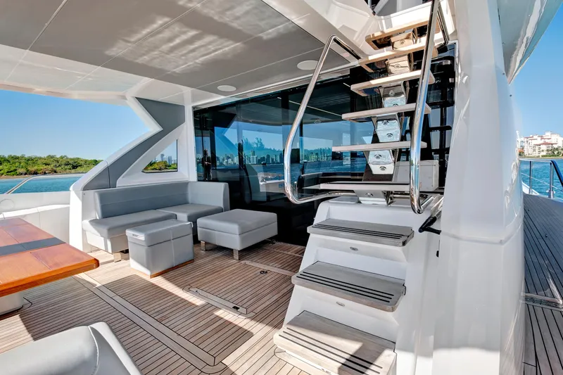 Misty K Yacht Photos Pics Luxurious 2024 Sunseeker 76 Yacht deck with modern seating and sleek staircase.