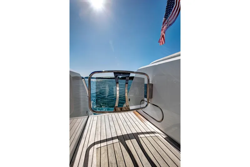 Misty K Yacht Photos Pics 2024 Sunseeker 76 Yacht deck with ocean view and American flag.