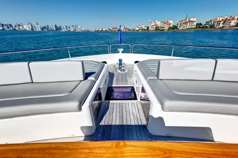 Misty K Yacht Photos Pics 2024 Sunseeker 76 Yacht deck with luxurious seating, overlooking a vibrant city skyline.
