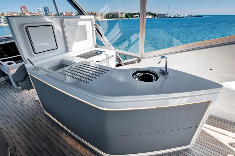 Misty K Yacht Photos Pics Luxurious 2024 Sunseeker 76 Yacht deck with modern outdoor kitchen and stunning ocean view.