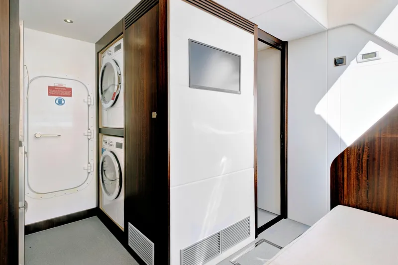 Misty K Yacht Photos Pics Laundry area inside 2024 Sunseeker 76 Yacht, featuring modern appliances and sleek design.