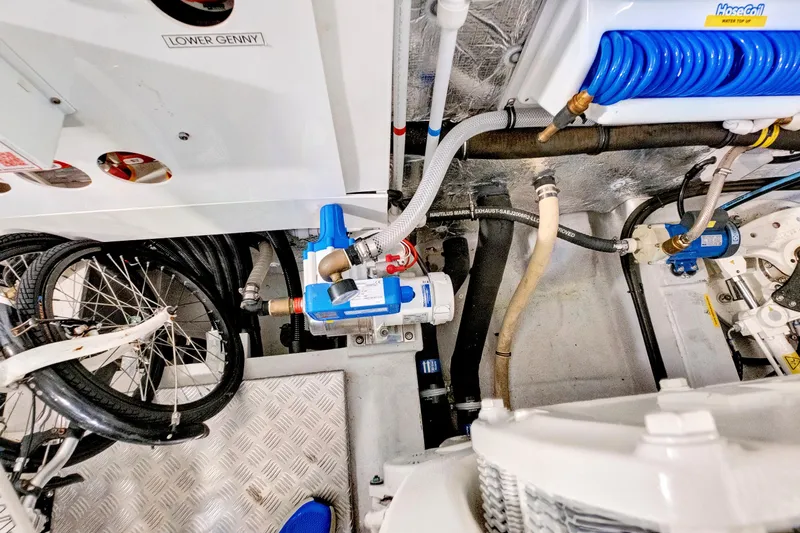 Misty K Yacht Photos Pics Engine room of 2024 Sunseeker 76 Yacht with mechanical components and coiled hose.