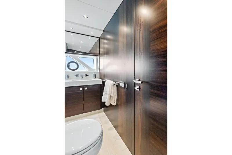 Misty K Yacht Photos Pics Luxurious bathroom interior of 2024 Sunseeker 76 Yacht with sleek wood finishes.