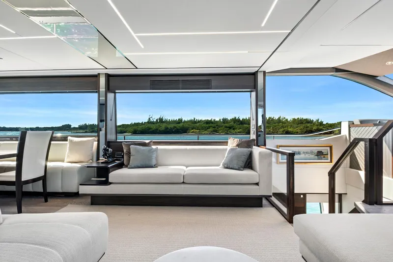 Misty K Yacht Photos Pics Luxurious interior of 2024 Sunseeker 76 Yacht with panoramic windows and elegant seating.