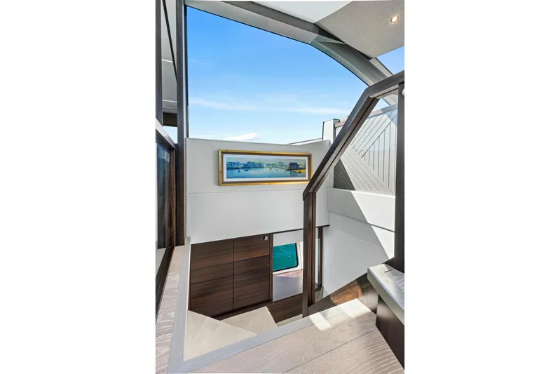 Misty K Yacht Photos Pics Interior staircase of 2024 Sunseeker 76 Yacht with modern design and artwork.