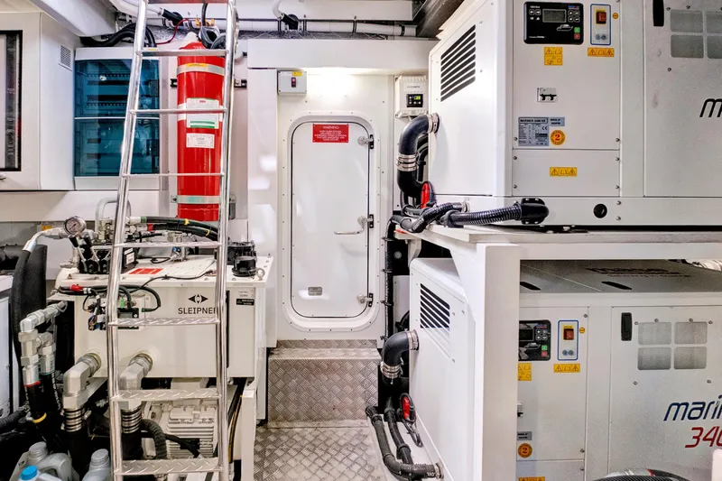 Misty K Yacht Photos Pics Engine room of 2024 Sunseeker 76 Yacht with equipment and access door.