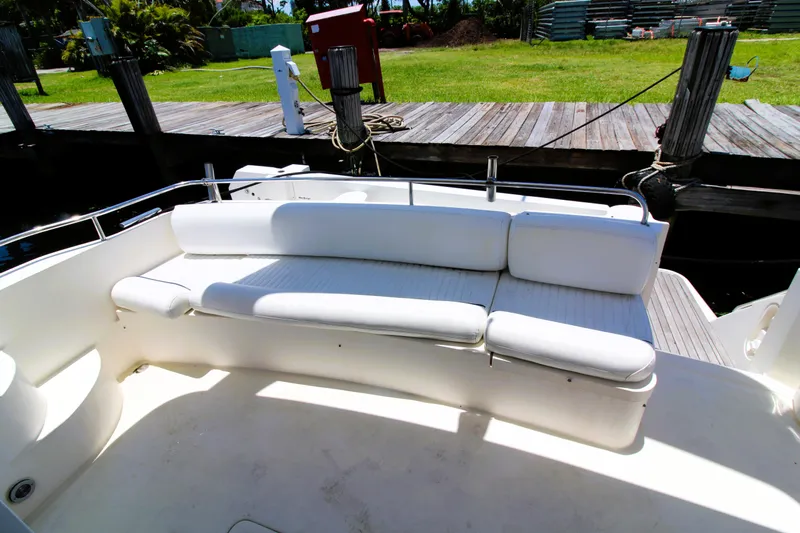 Empty Pockets Yacht Photos Pics ```json{  "alt_text": "1997 Viking Sport Cruisers 48SC yacht with white seating area."}```