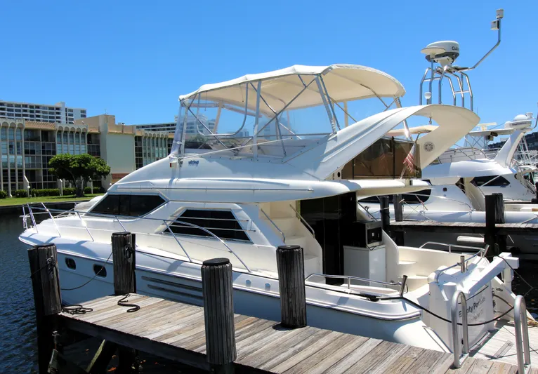 Empty Pockets Yacht Photos Pics 1997 Viking Sport Cruisers 48SC yacht docked at marina under clear blue sky.