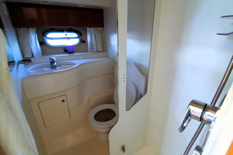 Empty Pockets Yacht Photos Pics Bathroom interior of 1997 Viking Sport Cruisers 48SC yacht, featuring sink and toilet.
