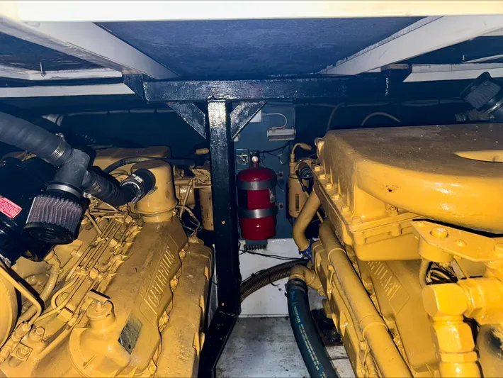 Empty Pockets Yacht Photos Pics Engine room of 1997 Viking Sport Cruisers 48SC with dual engines and fire extinguisher.