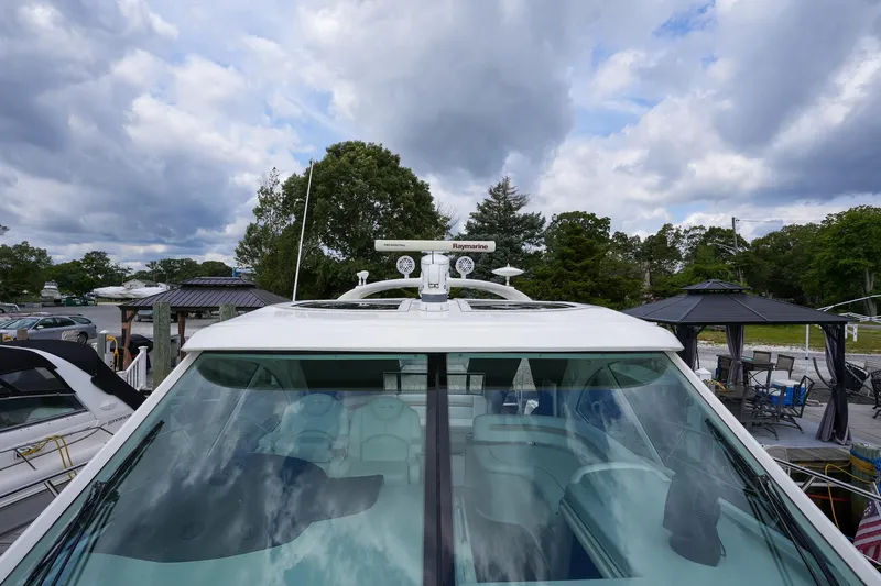  Yacht Photos Pics Sea Ray 500 Sundancer 2010 yacht with radar, docked under cloudy sky.