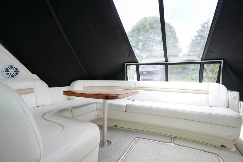  Yacht Photos Pics Luxurious interior of 2010 Sea Ray 500 Sundancer with white leather seating and wooden table.