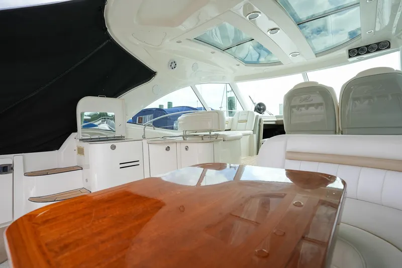  Yacht Photos Pics Interior of 2010 Sea Ray 500 Sundancer yacht with luxurious seating and wooden table.