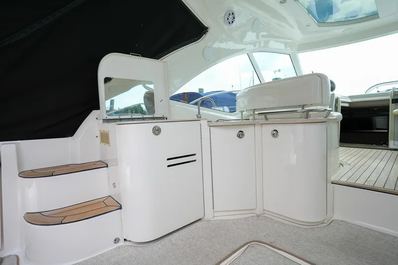  Yacht Photos Pics Interior of 2010 Sea Ray 500 Sundancer yacht with white cabinetry and wooden steps.