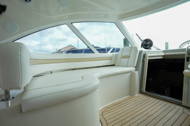  Yacht Photos Pics Interior of 2010 Sea Ray 500 Sundancer yacht with white seating and wooden flooring.