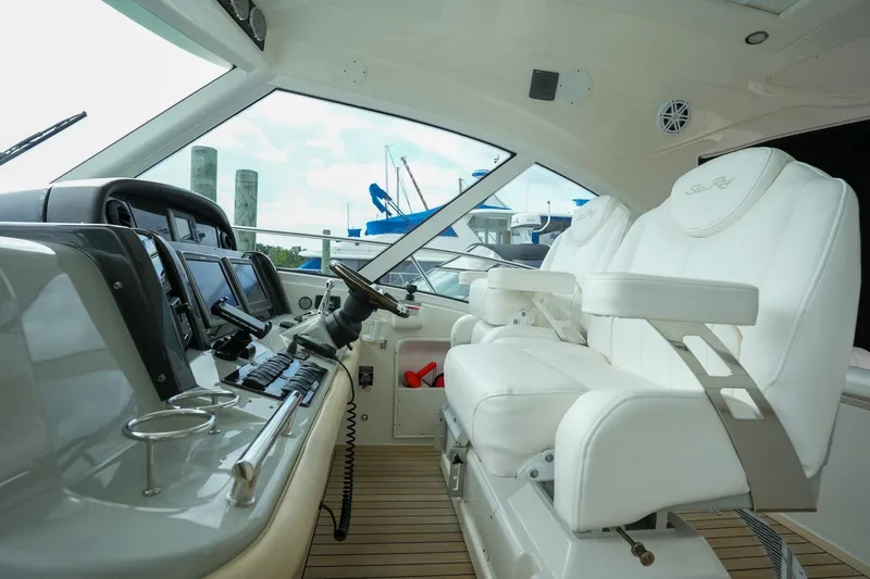  Yacht Photos Pics Cockpit of 2010 Sea Ray 500 Sundancer with white captain's chair and advanced navigation equipment.