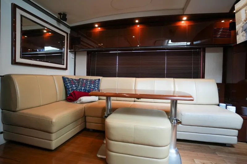  Yacht Photos Pics Luxurious interior of 2010 Sea Ray 500 Sundancer yacht with leather seating and wooden table.