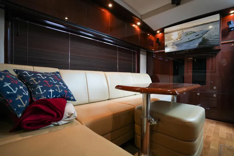  Yacht Photos Pics Luxurious interior of 2010 Sea Ray 500 Sundancer yacht with leather seating and wooden table.