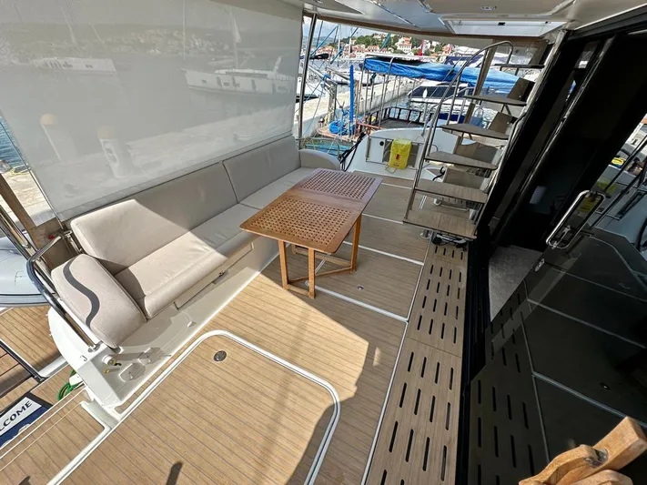  Yacht Photos Pics Spacious deck of 2021 Fountaine Pajot MY6 yacht with seating and table.