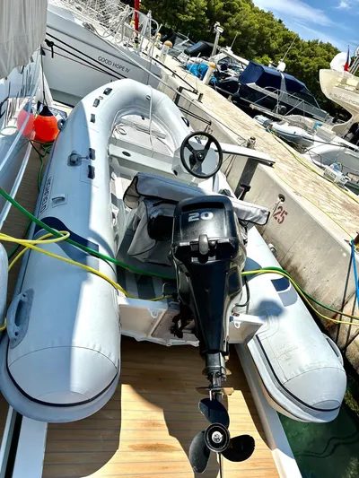  Yacht Photos Pics Inflatable boat with outboard motor docked beside a 2021 Fountaine Pajot MY6 yacht.