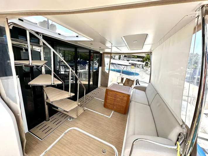  Yacht Photos Pics Luxurious 2021 Fountaine Pajot MY6 yacht interior with spiral staircase and comfortable seating.