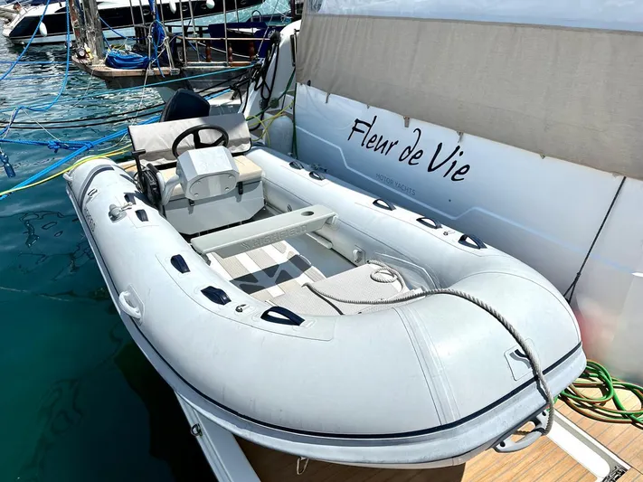 Yacht Photos Pics Inflatable boat docked beside 2021 Fountaine Pajot MY6 yacht, "Fleur de Vie," in marina.