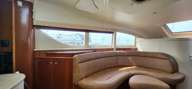  Yacht Photos Pics Luxurious 2005 Sea Ray 390 Motor Yacht interior with elegant leather seating and panoramic windows.