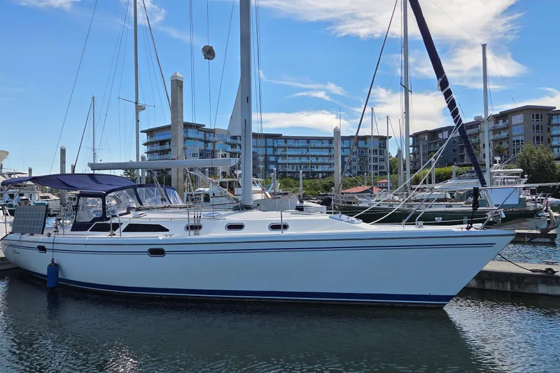  Yacht Photos Pics 2007 Catalina 42 MkII sailboat docked in marina with modern buildings in background.
