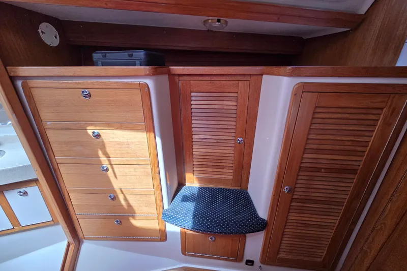  Yacht Photos Pics Interior of 2007 Catalina 42 MkII sailboat with wooden cabinets and cushioned seat.