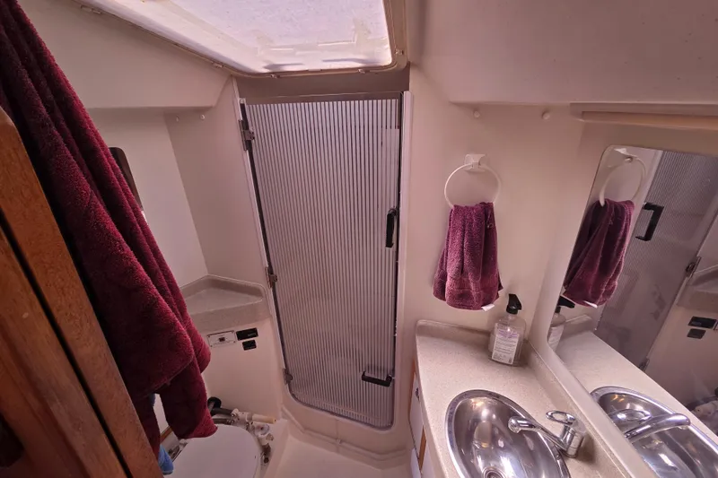  Yacht Photos Pics Bathroom interior of 2007 Catalina 42 MkII yacht with sink, mirror, and shower.