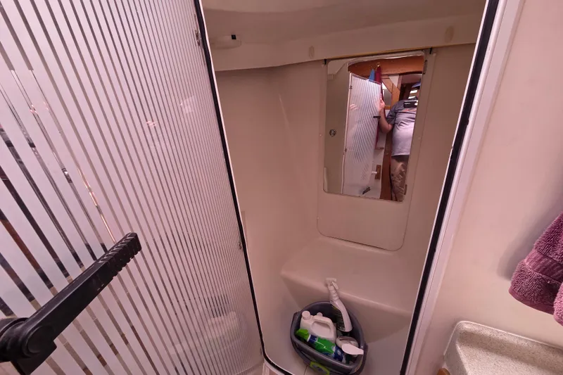  Yacht Photos Pics Interior of 2007 Catalina 42 MkII sailboat bathroom with shower and cleaning supplies.