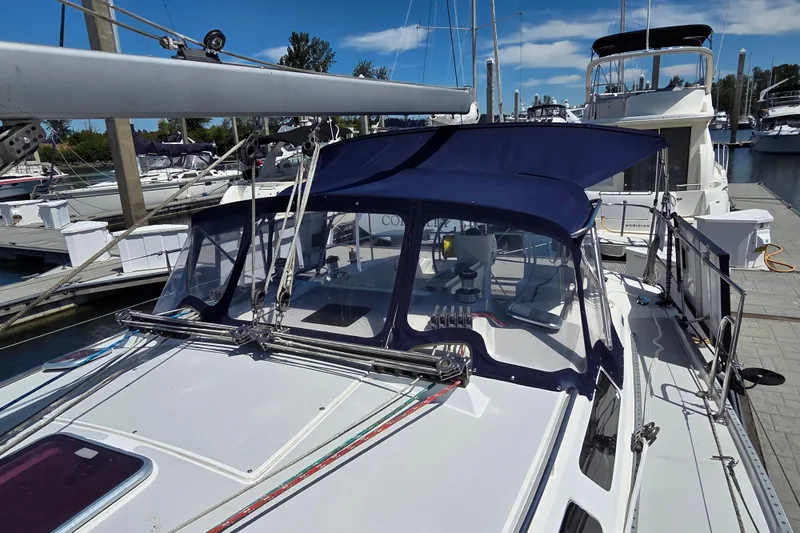  Yacht Photos Pics 2007 Catalina 42 MkII sailboat docked at marina with blue canopy and clear skies.
