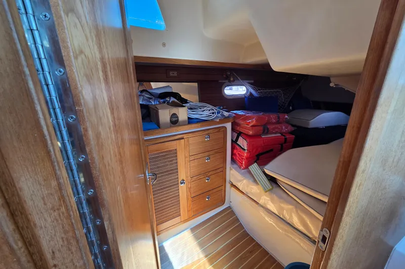  Yacht Photos Pics Cozy cabin interior of 2007 Catalina 42 MkII sailboat with wooden cabinetry and storage.