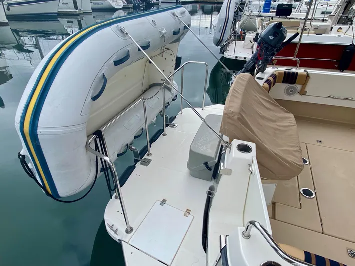 Sea Dreamer Yacht Photos Pics 2014 Cutwater 30 Sedan with inflatable dinghy on stern, docked at marina.