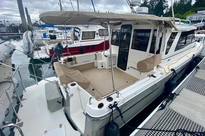 Sea Dreamer Yacht Photos Pics 2014 Cutwater 30 Sedan docked at marina, featuring spacious deck and canopy.