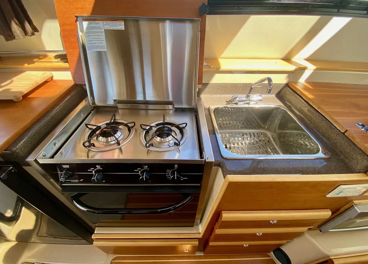 Sea Dreamer Yacht Photos Pics Compact kitchen in 2014 Cutwater 30 Sedan with stove and sink.