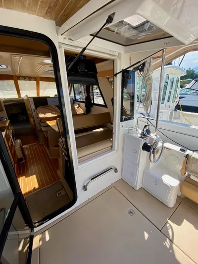 Sea Dreamer Yacht Photos Pics 2014 Cutwater 30 Sedan interior with helm, seating, and wood accents.