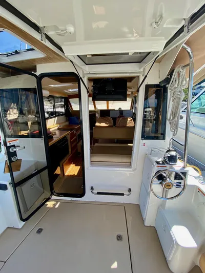 Sea Dreamer Yacht Photos Pics Interior view of a 2014 Cutwater 30 Sedan boat, featuring helm and cabin entry.