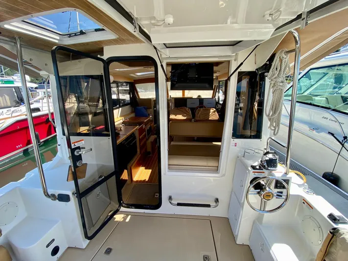 Sea Dreamer Yacht Photos Pics 2014 Cutwater 30 Sedan boat interior with open doors and steering wheel.