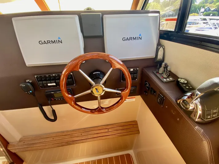 Sea Dreamer Yacht Photos Pics Helm of 2014 Cutwater 30 Sedan with Garmin displays and wooden steering wheel.