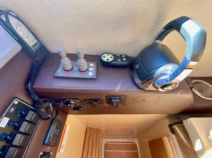 Sea Dreamer Yacht Photos Pics Control panel of a 2014 Cutwater 30 Sedan boat with joystick and headset.